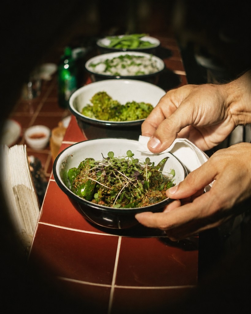 Chef finishing a bowl with microgreens